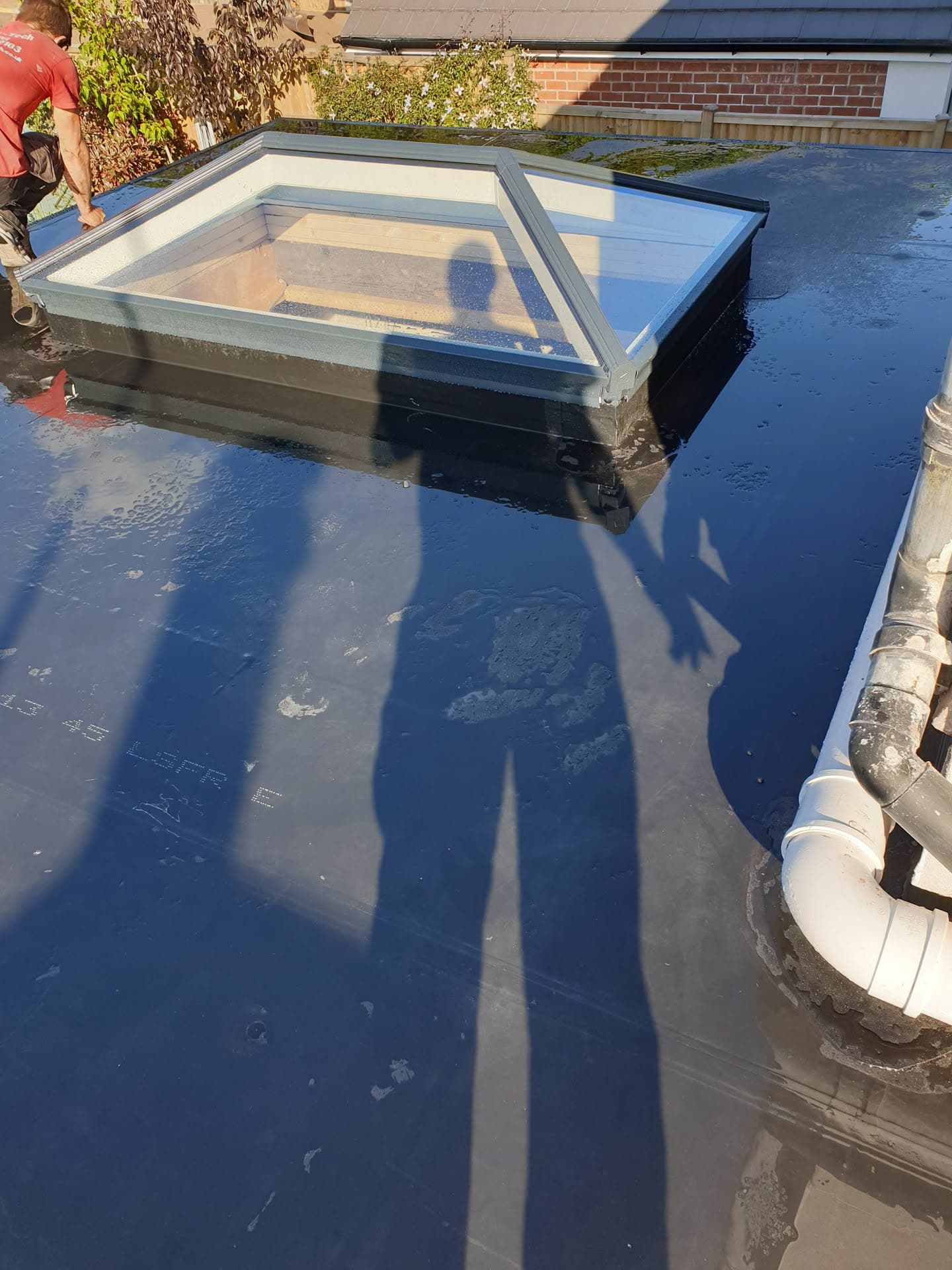 Flat roof with blue GRP fibreglass coating and roof lantern skylight