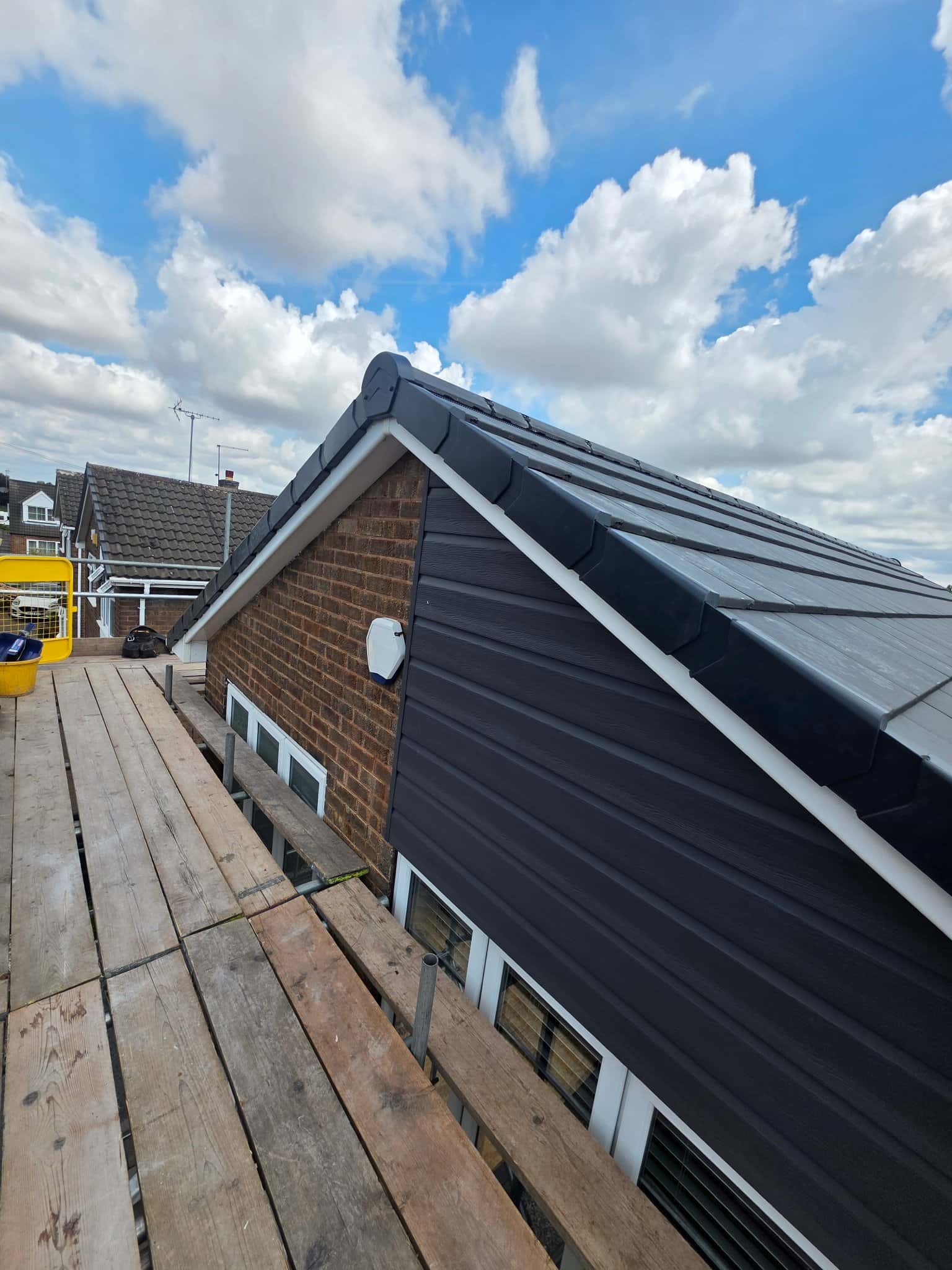 Finished gable end with dry verge and new guttering after a roof replacement