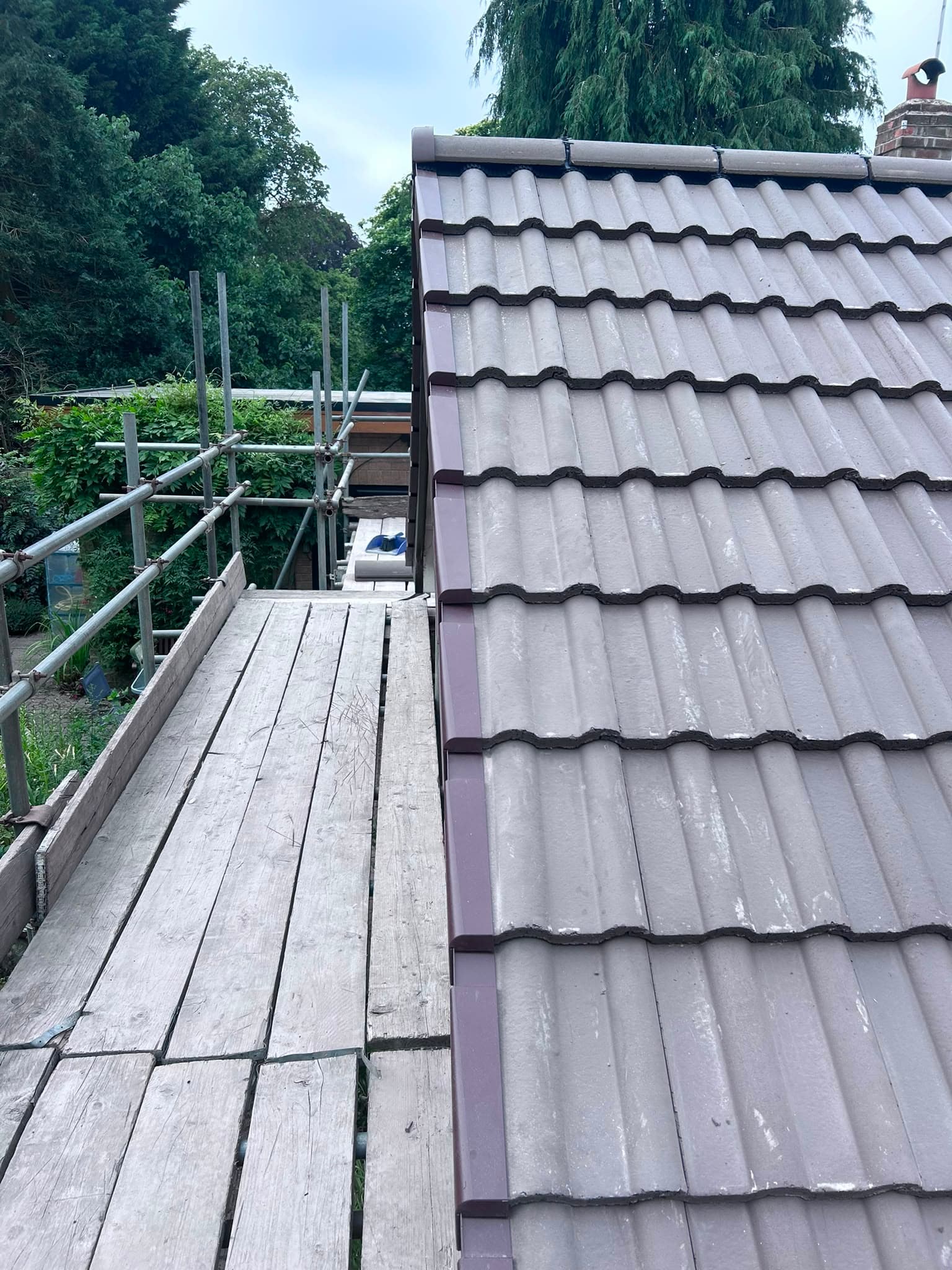 Newly completed pantile roof with dry verge, seen from the scaffold before it comes down